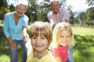 Senior couple on country walk with grandchildren