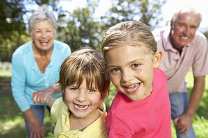 Senior couple on country walk with grandchildren