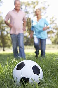 Senior couple playing football