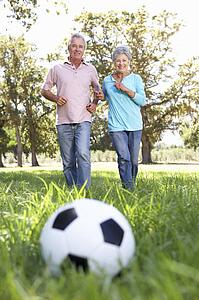 Senior couple playing football