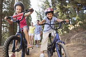 Family on country walk with bikes