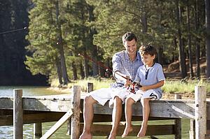 Father and son fishing together