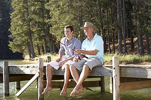 Father and adult son fishing together
