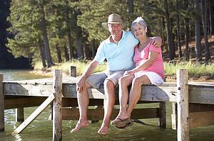 Senior couple sitting by lake