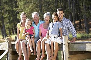 3 Generation family sitting by lake