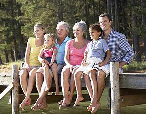 3 Generation family sitting by lake