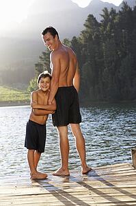Father and son standing on jetty
