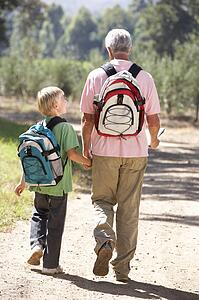 Senior man and grandson on country walk