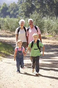 Senior couple and grandchildren on country walk