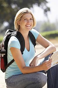 Woman with map on country walk