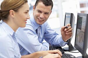 Business man and woman working on computers