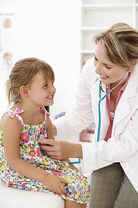 Female doctor examining child