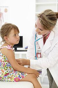 Female doctor examining child