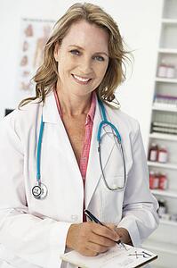 Mid age female doctor writing prescription