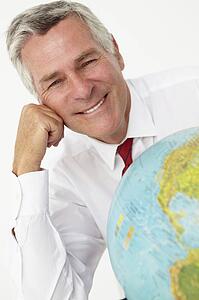 Senior businessman with globe