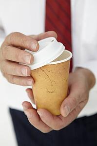 Businessman holding takeout coffee