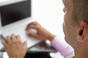 Young businessman using laptop