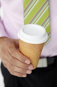 Businessman holding takeout coffee