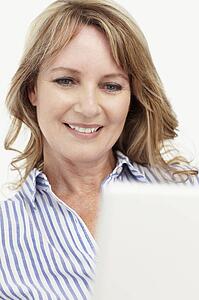 Mid age businesswoman using laptop