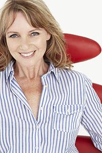 Mid age businesswoman relaxing in chair