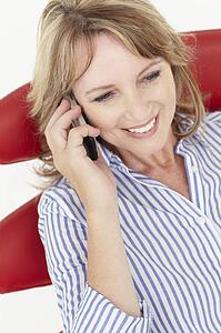 Mid age businesswoman using cellphone