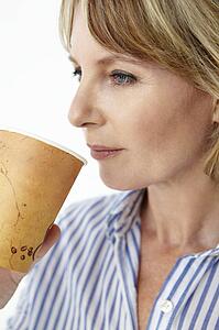 Businesswoman drinking takeout coffee