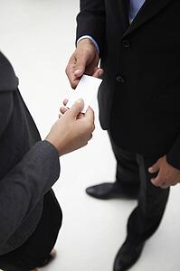 Detail businessman and woman exchanging cards