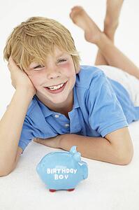 Young boy with piggy bank