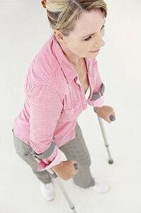 Woman walking with crutches
