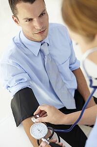 Young man having blood pressure taken