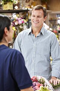 Man serving customer in florist