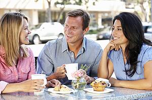 Friends chatting outside cafÃ©