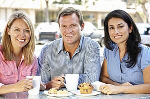 Friends chatting outside cafÃ©