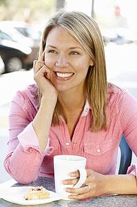 Woman sitting at sidewalk cafÃ©