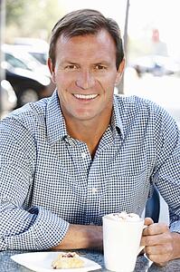 Man sitting at sidewalk cafÃ©