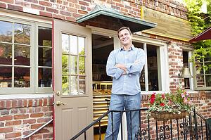 Man standing outside bakery/cafÃ©