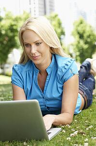 Woman using laptop in city park