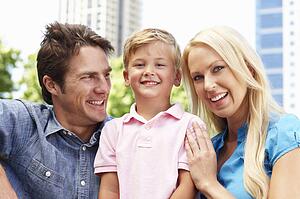 Couple in city park with young son