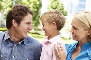 Couple in city park with young son