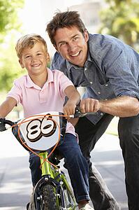 Father with boy on bike