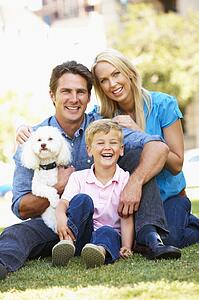 Couple in city park with young son and dog