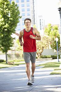 Man running in city park