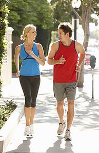 Couple running on city street
