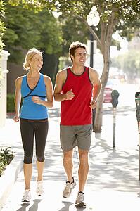 Couple running on city street