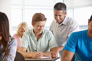 Tutor helping student in class