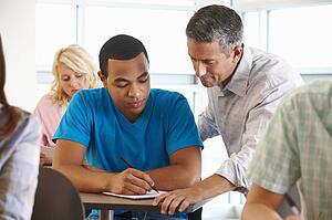 Tutor helping student in class