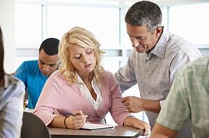 Tutor helping student in class
