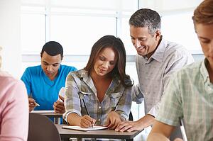 Tutor helping student in class