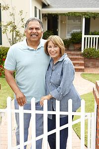 Senior Hispanic couple outside home
