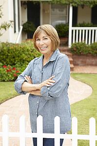 Senior Hispanic woman outside home